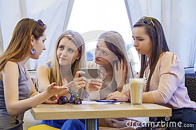 Group Of Young Women Sitting Around Table Eating Dessert Stock Photo