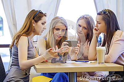 Group Of Young Women Sitting Around Table Eating Dessert Stock Photo