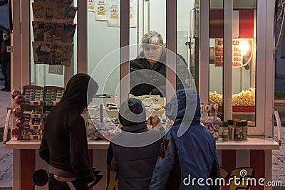 group of youngsters, boys, Serbs, waiting in line in the streets of Novi Sad in front of a popcorn stand, or Kocice Editorial Stock Photo