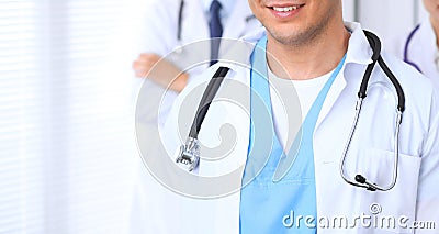 Groupe of unknown doctors standing straight in hospital office. Close Up of stethoscope at practitioner breast Stock Photo