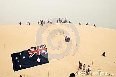 Tourists sliding sand board down the sand dunes in Port Stephen, Australia Editorial Stock Photo