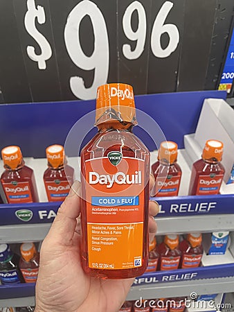 Walmart grocery store hand holdiing DayQuil Editorial Stock Photo