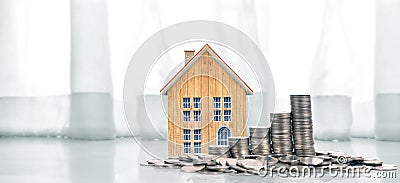Growing coins house on stack coins. Concept of Investment propert Stock Photo
