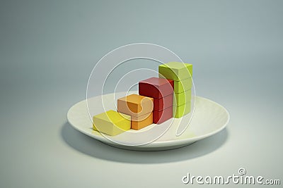 growing financial chart of four bars of different colors on a white plate Stock Photo