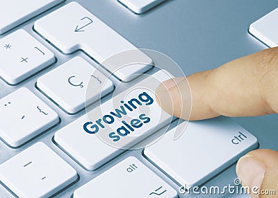 Growing sales - Inscription on Blue Keyboard Key Stock Photo