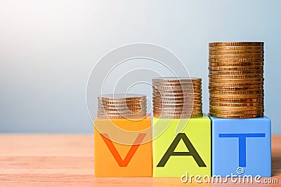 Growing taxes - colour blocks with VAT and money stacks Stock Photo