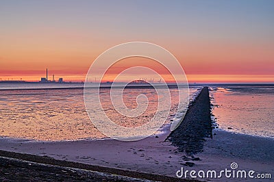 A groyne in the bay Jadebusen during beautiful sunset Stock Photo