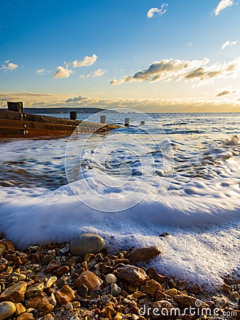 Groynes at sunset in Milford-on-Sea stock Stock Photo