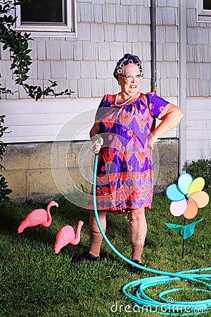 Grumpy granny dislikes yard work Stock Photo