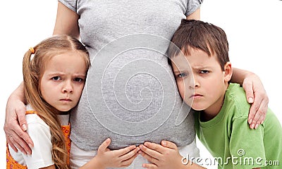 Grumpy kids not happy about their new sibling Stock Photo