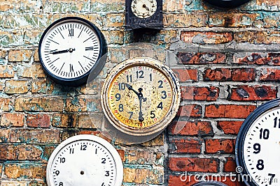 Grunge background with old watch. Time concept. Retro clocks on the wall. Old antique clock on aged red brick wall background. Stock Photo