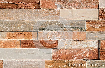 Grunge brown stone wall tiles texture. Wall panel natural brown,orange stone dirty,dust with pattern for architecture and interior Stock Photo