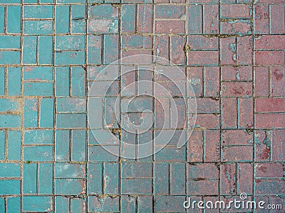 Grunge cracked red street tiles, blue paint. City street pavement cobblestone Stock Photo