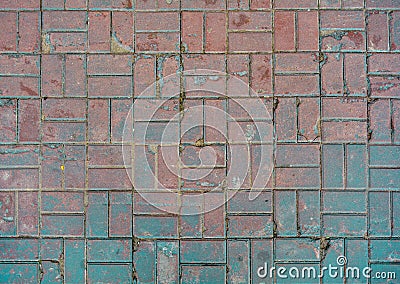 Grunge cracked red street tiles, blue paint. City street pavement cobblestone Stock Photo