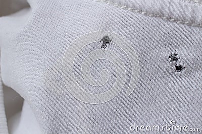 Grunge damaged cloth for background. Gray white fabric with holes. Crumpled torn Stock Photo