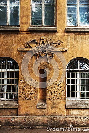 Grunge freemasonry emblem on a dramatic background - masonic triangle and compass, closeup of old architectural building Stock Photo