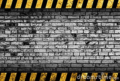 Grunge grey brick wall background with warning stripes Stock Photo