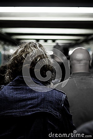 Grunge portrait of older woman walking through crowded hallway. Curly humid dry hair. Scary mood Editorial Stock Photo