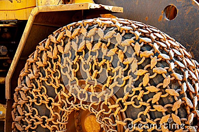 Heavy machinery tractor wheel chains. Detail view of construction machine Stock Photo