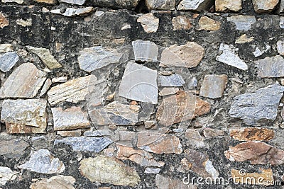 Grunge texture stone wall background. Grungy aged stonework city. Front antique decor house. General layout of stone masonry Stock Photo