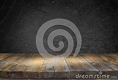 Grunge vintage wooden board table in front of black textured background Stock Photo