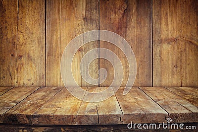 Grunge vintage wooden board table in front of old wooden background. Ready for product display montages Stock Photo