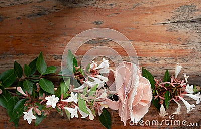 Bouquet of white flowers mixed with a fabric flower on rustic wooden background.Copy space Stock Photo