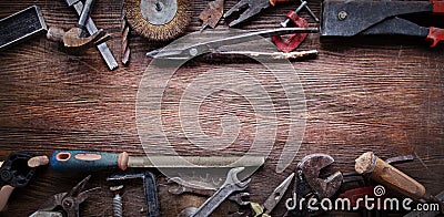 Grungy old tools on a wooden background Stock Photo