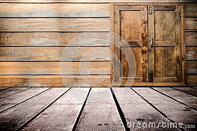 Grungy textured red brick and stone wall with warm brown wooden floor inside old neglected and deserted interior, masonry and carp Stock Photo