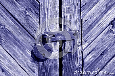 Grungy wooden door with lock in blue tone Stock Photo