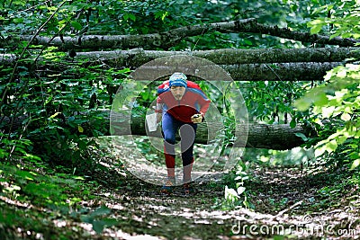 GRUNIVKA, SUMY REGION, UKRAINE - JUNE 21, 2021: Sportsman running through the forest on the race of SKIF Cup XIV sports Editorial Stock Photo
