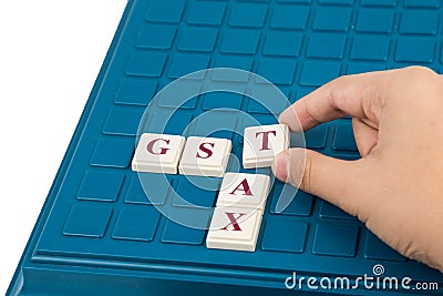 GST TAX concept with crossword on a board game Stock Photo