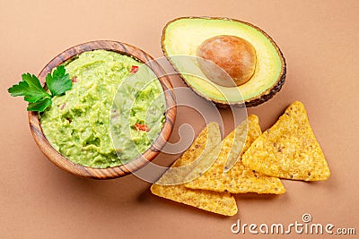 Guacamole bowl avocado and chips isolated on table. Flat lay Stock Photo