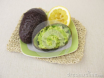 Guacamole with lemon in avocado peel Stock Photo