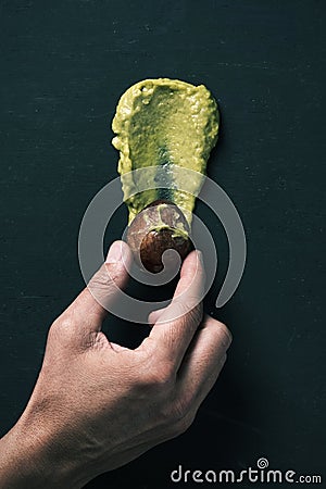 Guacamole or smashed ripe avocado and pit Stock Photo