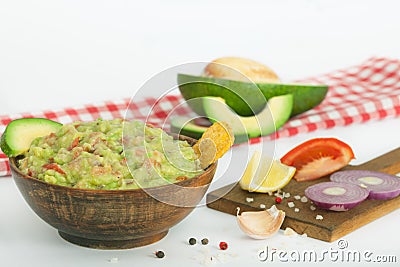 Guacamole with vegetables and snacks in a wooden bowl, vegan snack, vegetarian concept dinner. Stock Photo
