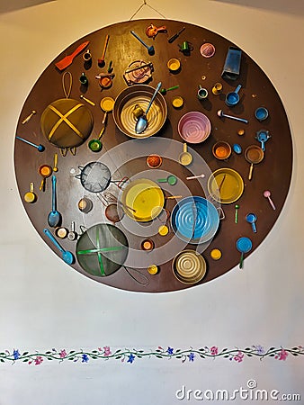 Unique kitchen-themed wall art creatively using colorful utensils and plates Editorial Stock Photo