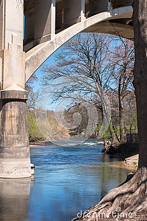 Guadalupe River as it flows under I35 bridge Stock Photo