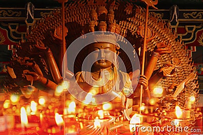 Guan Yin sculpture Thousand Hand carved of wood candle ligh Stock Photo