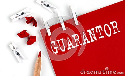 GUARANTOR text on red paper with office tools on white background Stock Photo