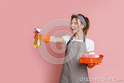 On Guard Of Cleanliness. Cherful Housemaid Playfully Aiming With Sprayer Detergent Stock Photo