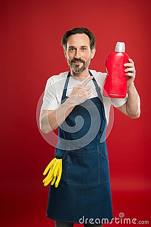 On guard of cleanliness and order. Cleaning service and household duty. Man in apron with gloves hold plastic bottle Stock Photo