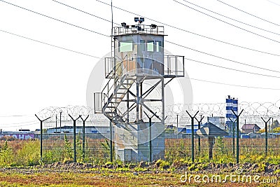 Guard tower and fence around a military unit. Russia. Siberia Editorial Stock Photo