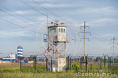 Guard tower and fence around a military unit. Russia. Siberia Editorial Stock Photo