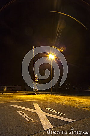 Guarded level crossing at night in Kingman Stock Photo