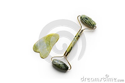 Guasha green natural gemstone face roller. Anti aging self care tool. Stock Photo