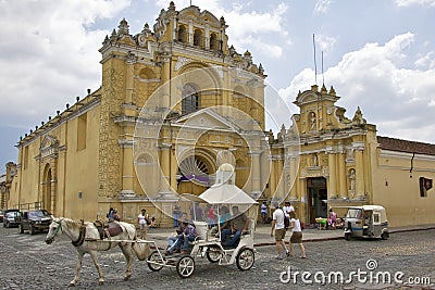 Antigua, Guatemala - March 2013: Horse carriage running in the street of Antigua in Guatemala Editorial Stock Photo