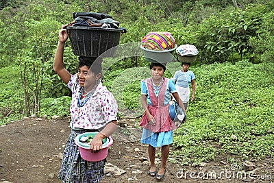 Guatemalan Indian women lugging laundry Editorial Stock Photo