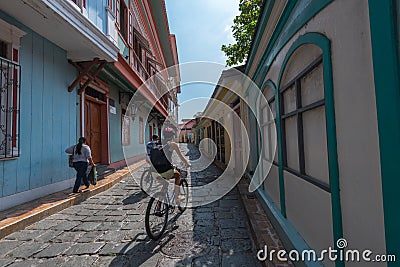 Cyclists on a Side Street Editorial Stock Photo