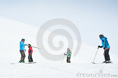 Gudauri, Georgia - 24th january, 2022: Caucasian male ski instructor teaching to ski family two kids and father beginner skier in Editorial Stock Photo